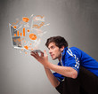 Handsome man holding laptop with graphs and statistics