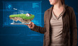 Photo: Woman presenting a perfect ecology land with a house and windmil Woman presenting a perfect ecology land with a house and windmil