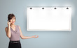 Photo: young woman standing next to a modern copy space and making phon young woman standing next to a modern copy space and making phon