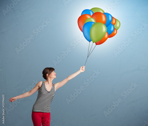 Photo: Young woman holding colorful balloons Young woman holding colorful balloons