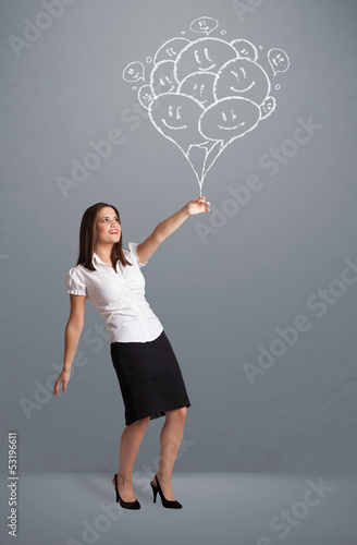 Photo: Happy woman holding smiling balloons drawing Happy woman holding smiling balloons drawing