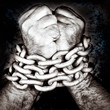 Hands locked by a strong chain on a black background