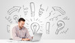 Photo: Young businessman brainstorming with drawn arrows and symbols Young businessman brainstorming with drawn arrows and symbols