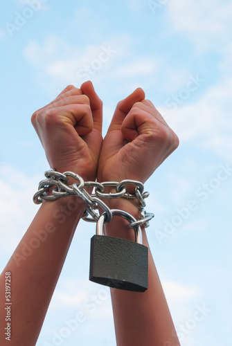 Photo: Hands tied up with chains Hands tied up with chains