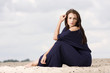 Foto: Sexy brunette posing in violet dress. Sexy brunette posing in violet dress.