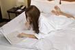 Portrait of beautiful woman with laptop on bed