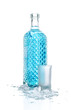 Bottle of vodka with wineglass and ice, isolated on white