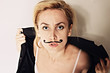 Photo: Young woman with painted mustache wearing jacket Young woman with painted mustache wearing jacket
