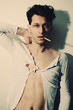 Young handsome man smoking a cigarette