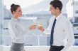 Photo: Serious business people clinking their flutes of champagne Serious business people clinking their flutes of champagne