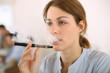 Photo: Portrait of woman smoking with electronic cigarette Portrait of woman smoking with electronic cigarette