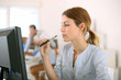 Photo: Girl smoking with electronic cigarette in office Girl smoking with electronic cigarette in office