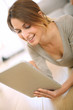 Smiling girl websurfing on internet with tablet