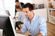 Man in office working on desktop computer
