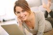 Photo: Smiling girl websurfing on internet with tablet Smiling girl websurfing on internet with tablet