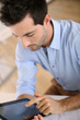 Upper view of smiling man using digital tablet