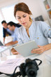 Girl in office working on digital tablet