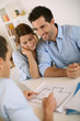 Foto: Young couple meeting architect for future house Young couple meeting architect for future house