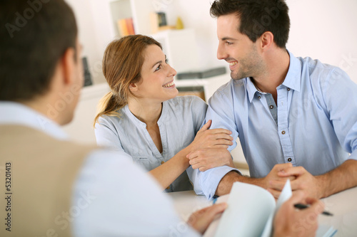 Photo: Young couple meeting construction planner Young couple meeting construction planner