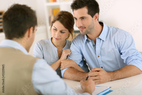 Photo: Young couple meeting construction planner Young couple meeting construction planner