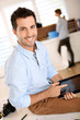 Trendy guy working in office with tablet