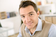 Smiling man sitting at desk in office
