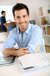 Portrait of cheerful man sitting in office