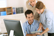 Photo: Office workers using tablet and computer Office workers using tablet and computer
