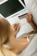 Back view of woman in sofa shopping on internet