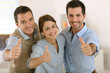Portrait of cheerful business team showing thumbs up