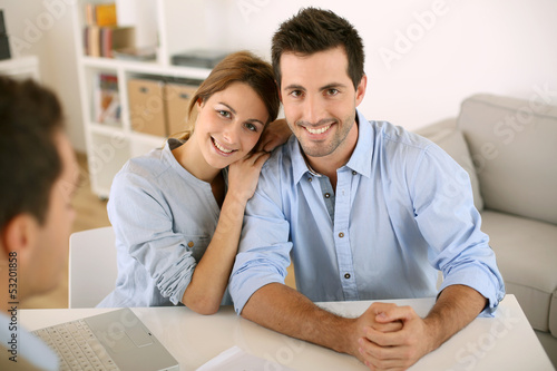 Photo: Smiling couple in real-estate agency Smiling couple in real-estate agency