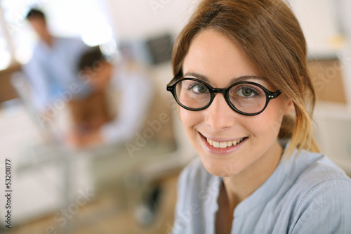 Photo: Cheerful student girl wearing eyeglasses Cheerful student girl wearing eyeglasses