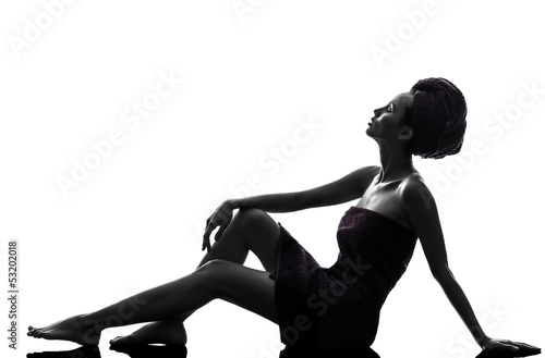 Photo: beautiful asian young woman looking up wrapped towel sitting on beautiful asian young woman looking up wrapped towel sitting on