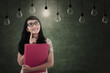 Asian female looking at light bulbs in class