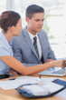 Photo: Smiling businesswoman showing partner something on a laptop Smiling businesswoman showing partner something on a laptop