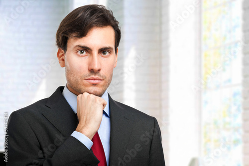Photo: Handsome businessman in his office Handsome businessman in his office