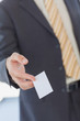 Foto: Businessman giving a white blank business card Businessman giving a white blank business card