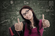 Asian female student give thumbs up in class