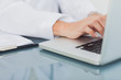 Doctor hands typing on a laptop