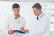 Photo: Doctors reading a folder Doctors reading a folder