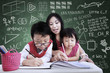 Beautiful teacher help children to write in class