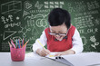 Photo: Cheerful boy drawing in class Cheerful boy drawing in class