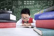 Close-up boy student reading books in class