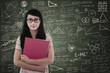 Confident female student standing in class