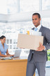 Photo: Upset businessman leaving the company Upset businessman leaving the company