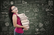 Beautiful female student bring pile of books in class