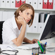 Photo: Office worker reading her monitor Office worker reading her monitor