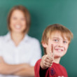 Photo: Young boy giving a thumbs up gesture Young boy giving a thumbs up gesture