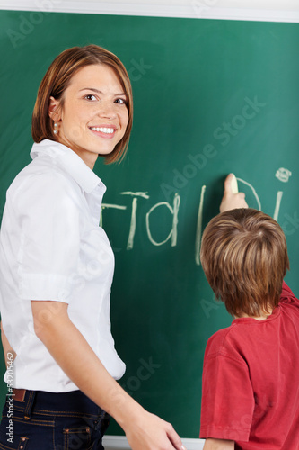 Photo: Teacher and young student Teacher and young student