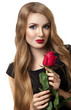 Stylish beautiful young woman holding red rose